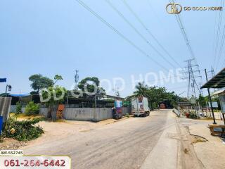 Residential street view with utility poles and several houses