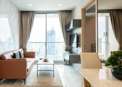 Modern living room with floor-to-ceiling windows and city view