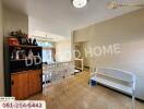 Dining area with table and chairs next to a decorative shelf and a white bench