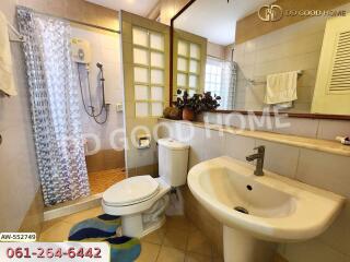 Spacious bathroom with modern amenities including a shower, toilet, and sink.