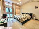 Spacious bedroom with a double bed and window letting in natural light