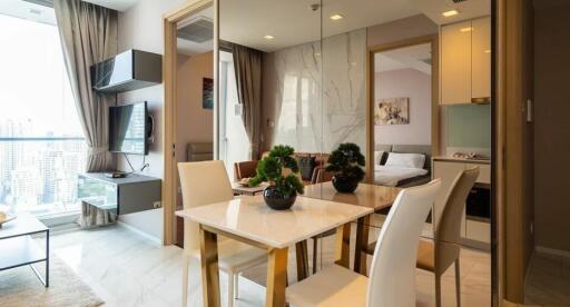 Modern dining area adjacent to a living room with a great view, next to a bedroom and kitchen