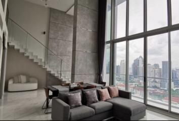 Modern living room with large windows and city skyline view