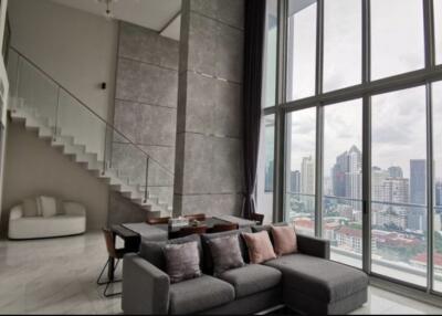 Modern living room with large windows, city view, and mezzanine