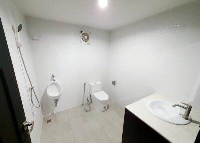 modern bathroom with toilet, urinal, shower, and sink