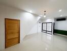 Spacious main living area with modern light fixtures and large windows