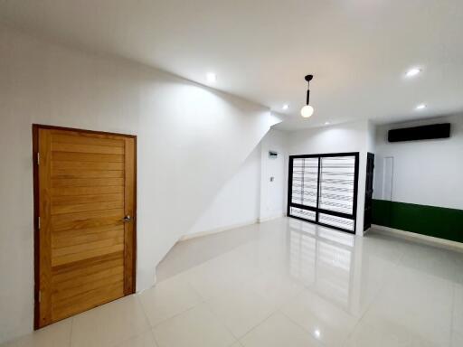 Spacious main living area with modern light fixtures and large windows