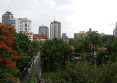View of city skyline with greenery