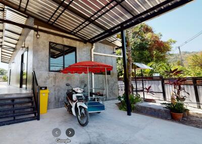 Exterior area with motorcycle and canopy