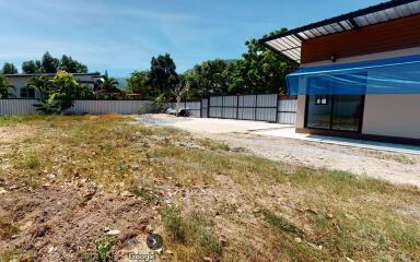 Side view of a house with a yard