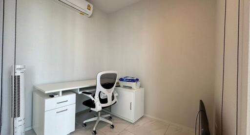 A modern study room with a desk, office chair, and air conditioning