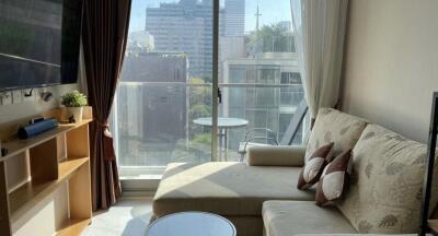 Spacious living room with large window and city view