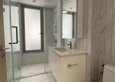 Modern bathroom with a glass shower enclosure and white vanity