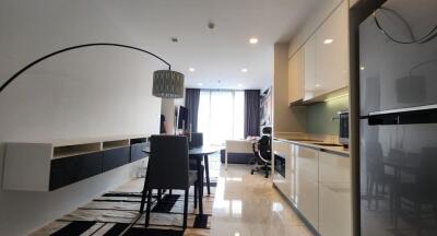 Modern open-plan living and kitchen area with dining table and contemporary furnishings