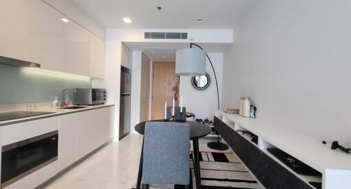 Modern dining area adjacent to kitchen with stylish decor