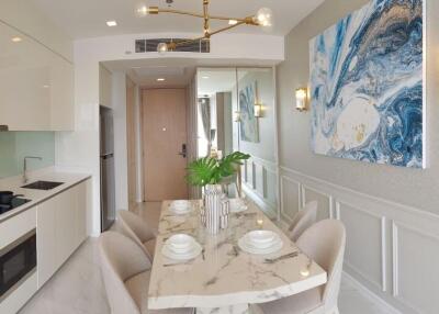Modern dining area with white marble table and contemporary artwork