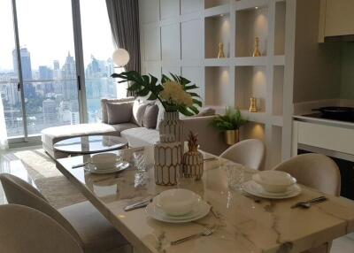Modern dining table set in an open-layout living room with a city view