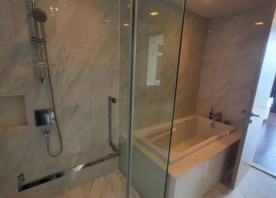 Modern bathroom with glass-enclosed shower and bathtub