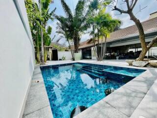 Outdoor pool area with surrounding trees