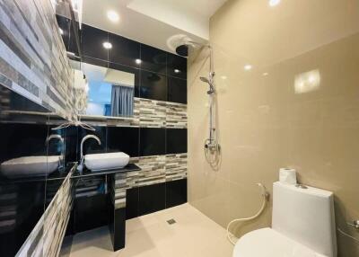 Modern bathroom with a sink, shower, and toilet