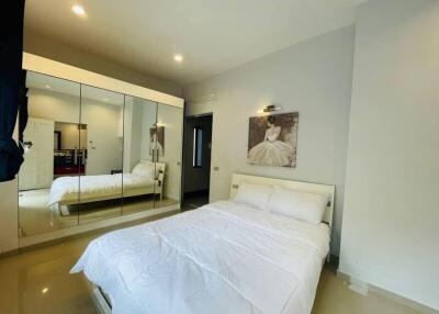 Bright and modern bedroom with large mirrors and a double bed