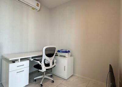 Small home office with desk, chair, cabinet, and air conditioner