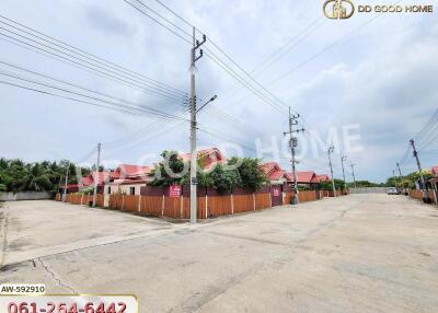 Street view of residential houses with red roofs and electric poles