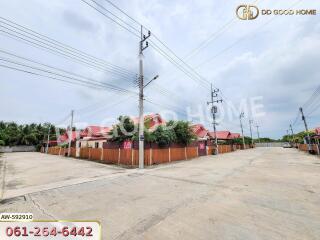 Street view of residential houses with red roofs and electric poles