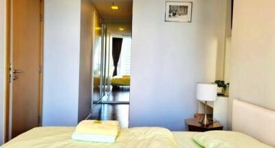 Modern bedroom entry with mirrored closet and natural light