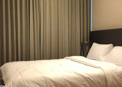 Well-lit bedroom with a double bed and neutral-toned curtains