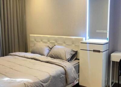 Modern bedroom with a double bed, nightstand, and dressing table