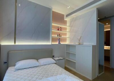 Modern bedroom with built-in shelving and ambient lighting