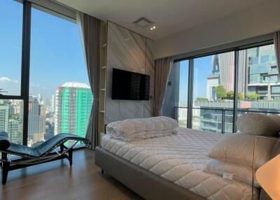 Spacious bedroom with city view and modern furnishings