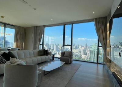 Spacious living room with large windows and city skyline view