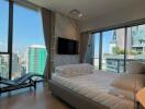 Modern bedroom with city view from large windows