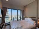 Modern bedroom with a large window offering a city view