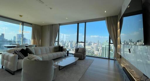 Modern living room with a cityscape view through large windows