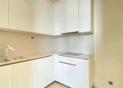 Modern kitchen with white cabinets and beige backsplash