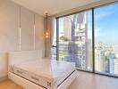 Bedroom with large window and city view