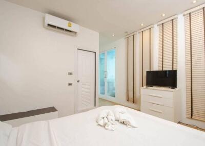 Modern bedroom with air conditioning and TV