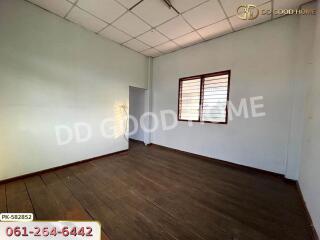 Empty bedroom with wooden floor and window