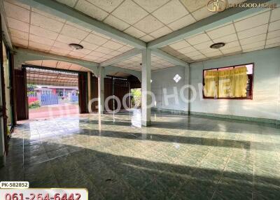 Spacious empty living area with tiled floors and large windows