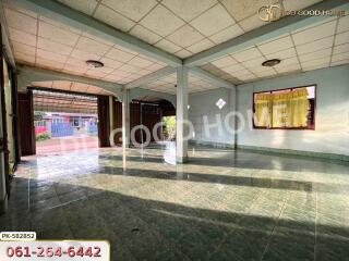 Spacious empty living area with tiled floors and large windows