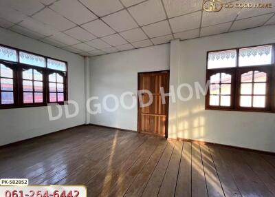 empty bedroom with wooden floor and windows