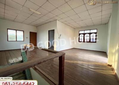 Main living space with wooden flooring and large windows