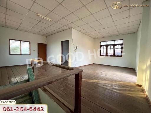 Main living space with wooden flooring and large windows