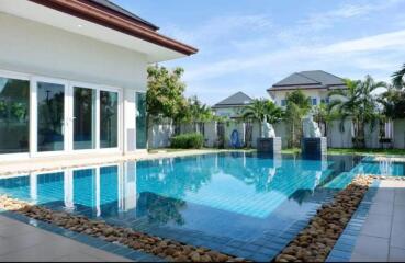 Luxury home outdoor area with swimming pool and garden