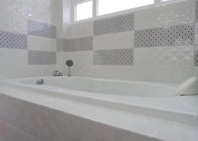 Modern bathroom with bathtub and decorative tiles