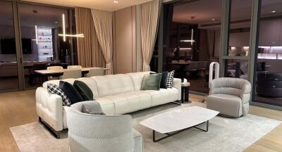 Modern living room with cream sofas and a contemporary chandelier