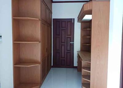 Bedroom with built-in wooden shelves and cabinets